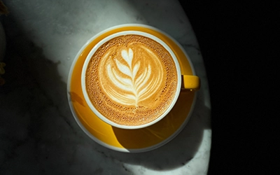 Picture of a coffee with a latte art on it.